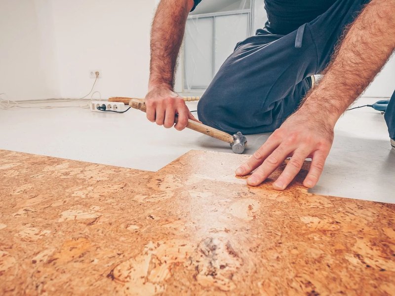 Installing cork flooring from A.T. Frank Floors Across Michigan